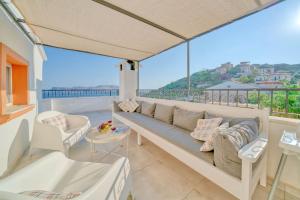 a living room with a couch on a balcony at Villa Pilu in Kaş
