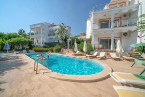a swimming pool in front of a house at Villa Pilu in Kaş