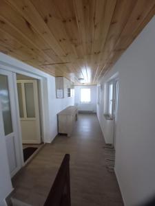 a hallway of a building with a wooden ceiling at Cabana Valea Arieșului in Arieşeni