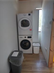 a laundry room with a washing machine and a washer at Flaherty Cottage, Ballyconneely in Ballyconneely