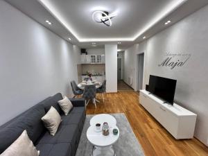 a living room with a couch and a table at Apartman Maja in Ruma