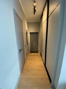 a hallway leading to a room with a door at The SiXth in Tukums