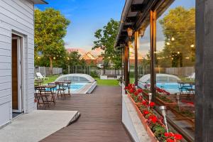 a deck with tables and chairs and a pool at Pensiunea Alina "Adults Only" in Sibiu