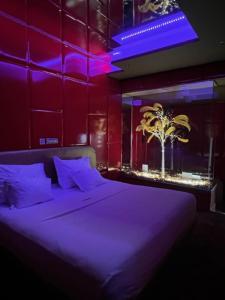 a bedroom with a large bed with purple lighting at V Hotel in Arroyomolinos