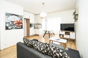 a living room with a couch and a table at Kerese Apartments in Pärnu