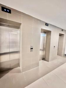 a row of elevators in a building at Aesthetic One Bedroom Beside SM w Pool, Wifi and Netflix in Cagayan de Oro