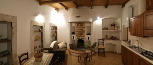 a kitchen with a living room with a fireplace at Le Siepi Country House in Santo Stefano di Sessanio