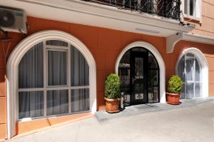 two arched entrances to a building with two potted plants at Hotel Art Nikola Rooms in Tbilisi City