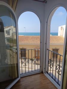 a balcony with two windows and a view of the ocean at Cabo de Palos VVMU 4780-1 in Cabo de Palos