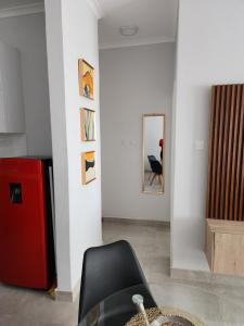 a living room with a black chair and a mirror at SaronaC102 in Gaborone