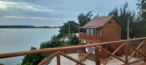 a wooden cabin with a view of a lake at Vilaria Tatajuba in Tatajuba