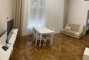a living room with a table and a couch at Apartments & Room - Korzo in Sombor