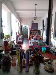 a living room with several vases on a table at Hostal Encuentro in Cali