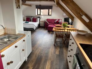 a kitchen and living room with a couch and a table at Studio Apartment in Wells