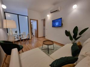 a living room with a couch and a table at Apartamentos San Isidro in Madrid