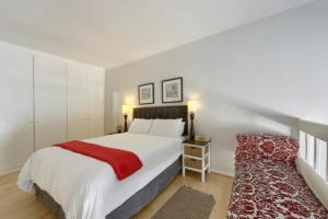 a bedroom with a large bed with a red blanket at Loft Apartment off Kloof with Table Mountain views in Cape Town