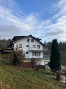 a large white house on top of a hill at Immensee in Ronshausen