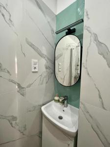 a bathroom with a sink and a mirror at Boutique HomeR1274 Apartment #3bedroom #freeparking in Budapest
