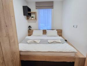 a bedroom with a large bed with two white pillows at Apartmá v klidné lokalitě Krkonoš. in Pec pod Sněžkou