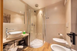 a bathroom with a shower and a sink and a toilet at Suite del Podesta' in Moena