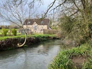 a river in front of a house with a house at Studio Apartment in Wells