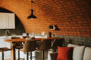 a kitchen with a wooden table and chairs at Otters View in Rhayader