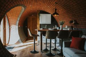 a kitchen with a brick wall and a table and chairs at Otters View in Rhayader +49 photos