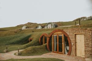 a building with a grassy hill with a door at Otters View in Rhayader