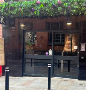 a store front with a glass door with plants on it at Hotel 105 in Liverpool