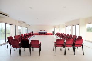 an empty room with red chairs and a table at Hotel Orchid Blue in Ināni