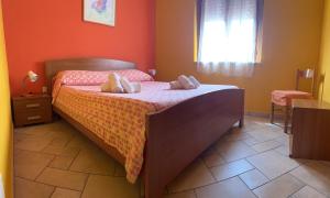 Ένα ή περισσότερα κρεβάτια σε δωμάτιο στο Appartamento ARANCIO