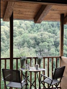 a table and two chairs on a porch with a view at Ai Tetti Nuovi in Roccaforte Mondovì