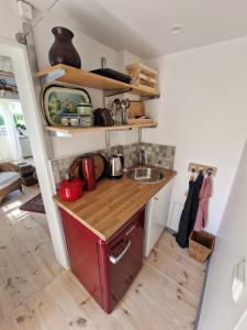 uma pequena cozinha com um lavatório e balcões de madeira em Seglarevistet 2 em Domsten