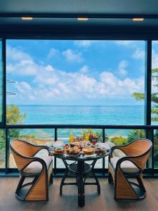 a table and chairs in a room with a view of the ocean at BİLİRİS HOTEL in Trabzon