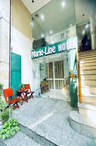 a store front of a mate line hotel with a table and chairs at Marieline Hotel Pham Ngu Lao in Ho Chi Minh City