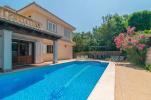 a swimming pool in front of a villa at Villa Son Serra in Son Serra de Marina