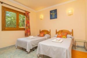 a room with two beds and a window at Villa Son Serra in Son Serra de Marina +36 photos