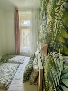 a bedroom with a bed and a window at Boutique HomeR1274 Apartment #3bedroom #freeparking in Budapest