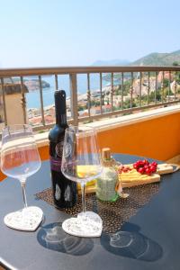 einen Tisch mit zwei Gläsern und einer Flasche Wein in der Unterkunft Azure Horizon in Dubrovnik