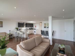 a living room with a couch and a kitchen at Flat 10 in Clacton-on-Sea