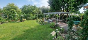 a garden with a picnic table and a gazebo at Bolek apartmany in Veľký Meder