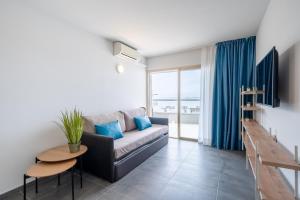 a living room with a couch and a table at Rentalmar Blue Beach Apartments & Pool in Salou