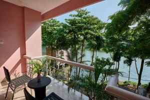 a balcony with chairs and a view of the water at Foy's Lake Resort in Chittagong