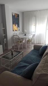 a living room with a couch and a table with chairs at MyHome in Noja