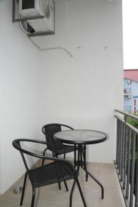 a table and two chairs sitting on a balcony at Lika Hotel in Ureki