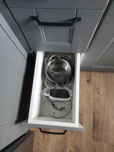 a cupboard with a pot and pans in it at Potal in Kremenchuk