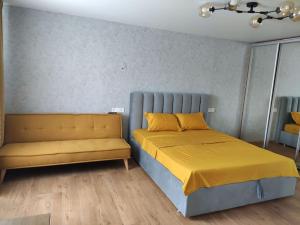 a bedroom with a bed and a couch at Potal in Kremenchuk