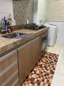 a kitchen with a sink and a stove at Apartamento Mari 4 in São Carlos