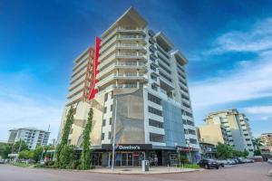 a tall building with a red sign on it at Kim on Smith, Darwin City in Darwin