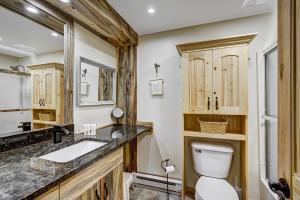 a bathroom with a toilet and a sink at Two Bedroom Condo with Parking, Pool, Hot Tub - Steps to Main Street in Breckenridge +28 photos